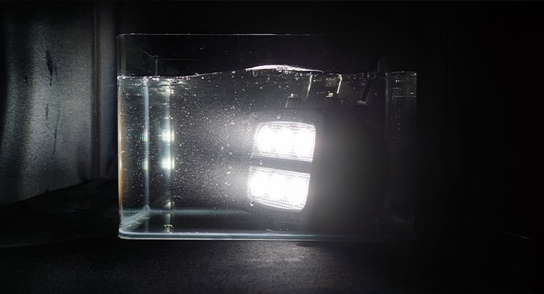 Waterproof LED tractor work light surviving spray exposure in field operation