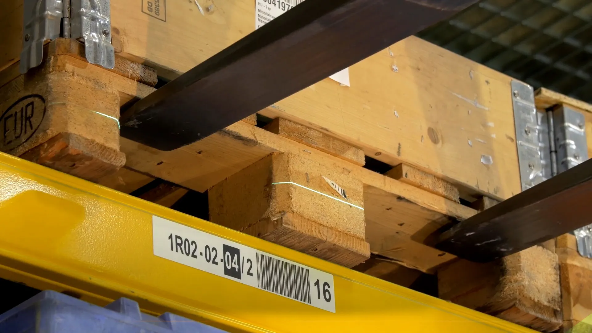 Pallet racking aisle in an automated warehouse where AGV protective and warning fields are configured